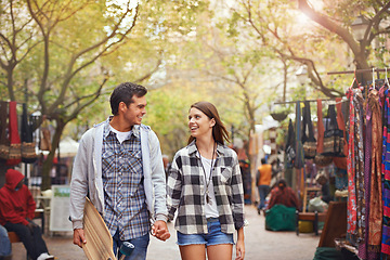 Image showing Happy, walking and couple holding hands on city journey, morning trip or skateboarding tour of urban Paris for outdoor adventure. Love, eye contact and young people bonding together on relax commute