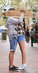 Image showing Couple, hide with skateboard and outdoor in city, hug and excited to learn together and romantic relationship. Cape town, touch and hobby with boyfriend and girlfriend in street, love and dating