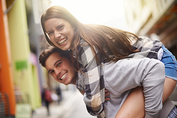 Image showing Happiness, hug and portrait of couple piggyback ride for fun urban adventure, bonding and city journey. Wellness, embrace and young man, woman or people smile for relationship, goofy game or break