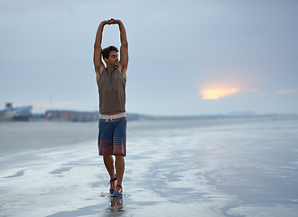 Image showing Health, stretching and beach with man, fitness and vacation with summer break and morning. Travel, ocean and person with holiday or seaside with with exercise, peaceful and water with wellness or sky