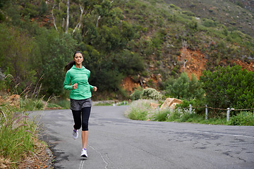 Image showing Running, fitness and woman on road on mountain for training, workout and exercise outdoors. Sports, nature and person on street for competition, race and challenge for health, wellness and cardio