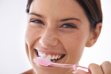 Image showing Toothbrush, happy and portrait of woman on a white background for dental care, oral hygiene or cleaning. Healthcare, whitening and face of person brushing teeth with toothpaste for wellness in studio