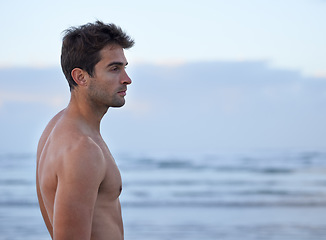 Image showing Thinking, fitness and calm man at a beach for wellness, training or reflection in nature topless. Memory, profile and male athlete at the ocean with peace, moment and break after running at the sea