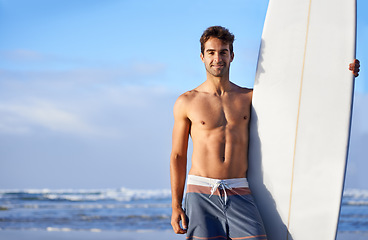 Image showing Beach, surfing and portrait of happy man with surfboard for, waves on summer vacation, weekend and holiday. Travel, nature and face of person by ocean for water sports, adventure and fun in Australia