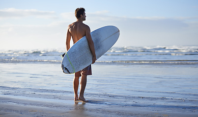 Image showing Fitness, surfing and back of man at a beach with surfboard for freedom, travel or sports outdoor. Ocean, training and male surfer at the sea for swimming, wellness or adventure, workout or holiday