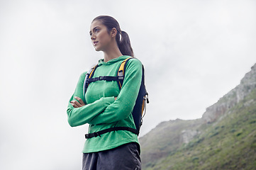 Image showing Arms crossed, hiking and woman with fitness, thinking and mountains with exercise and fresh air. Person, girl and hiker with wellness, nature and training for health and active with hobby and workout