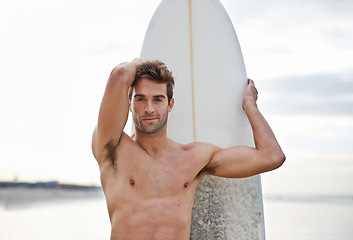 Image showing Man, portrait and surfboard on beach for waves, exercise or outdoor hobby in fitness, surfing or practice. Active male person or surfer with board for training at seaside or ocean coast in nature