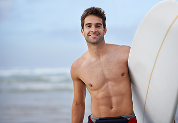 Image showing Happy man, portrait and surfboard on beach for waves, exercise or fitness in outdoor hobby, surfing or practice. Active male person or surfer smile with board for training, seaside or ocean coast