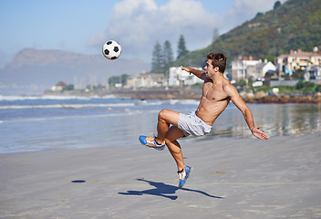 Image showing Man, beach and volley with soccer ball for game, sports or exercise in outdoor hobby, training or practice. Young male person or football player kicking in match or cardio workout by ocean coast