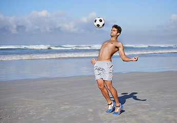 Image showing Man, beach and playing with soccer ball for game, sports or exercise in outdoor hobby, training or practice. Young muscular male person or football player in match or cardio workout by ocean coast