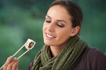 Image showing Woman, sushi and happy in home, hungry or eating with chopsticks for wellness, diet or ideas. Person, fish and smile for lunch, nutrition or snack with takeaway food in house, apartment and thinking