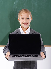 Image showing Child, girl and laptop screen in classroom for education, online school and marketing space against a chalkboard. Happy student or kid in portrait with computer mockup for e learning presentation