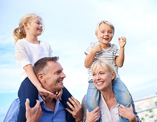 Image showing Smile, piggy back and parents with kids on outdoor adventure, vacation and travel on blue sky. Relax, sunshine and family, happy children with with mom and dad on summer holiday fun with support.