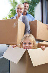 Image showing Moving, portrait and girl in box with parent, fun in new home and happy package with mortgage. Mother, father and playful child in cardboard with smile, hiding and property investment for family.