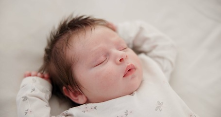 Image showing Tired baby, sleeping and nursery bed with morning, nap and dreaming of a young newborn at home. Cozy, sleepy kid and calm with health development from rest and peace in a house with closeup and care