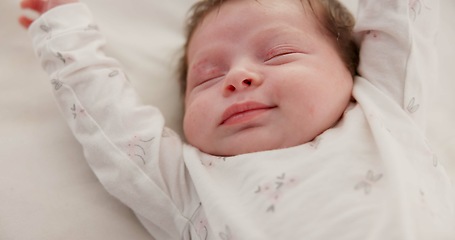 Image showing Baby, sleeping stretch and nursery bed with morning, nap and dreaming of a young newborn at home. Cozy, sleepy kid and calm with health development from rest and peace in house with closeup and care