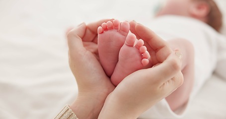 Image showing Feet, hands and mother with baby, love and support for care, health and wellness in bedroom. Closeup, family or mama with an infant, protection and child development with bonding or maternity in home