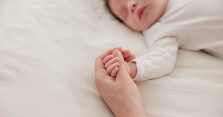 Image showing Sleeping, holding hands or mother with infant, love or support for care, health or wellness at home. Fingers, family or mama with a healthy baby, protection or child development for bond or maternity