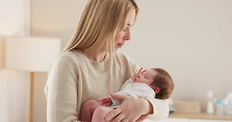 Image showing Family, kiss and a mother rocking her baby to sleep in the bedroom of their home together for love or care. Dreaming, nap or tired with a woman and newborn infant in an apartment to rest for growth