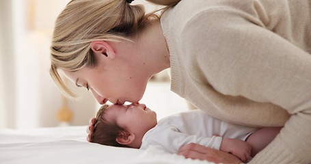 Image showing Happy, mother and baby kiss with love, care and support in a home with newborn and bonding. Morning, mom and relax infant with child security and motherhood in a family home on a bed with mama