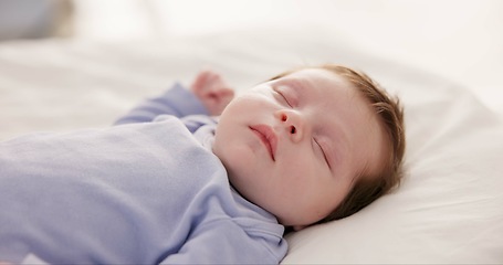 Image showing Relax, growth and sleep with a baby in a bedroom closeup in a home, dreaming during a nap for child development. Kids, calm and rest with an adorable newborn infant asleep on a bed for comfort