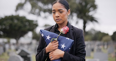 Image showing Funeral, death and rose for a woman with a flag at a cemetery in mourning at a memorial service. Sad, usa and an army wife as a widow with a flower in a graveyard feeling the pain of loss or grief