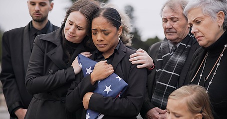 Image showing Sad, family and funeral with comfort, woman and support with compassion, empathy and depression. People, wife of loved one and friends with love, USA flag and sympathy with grief, goodbye or remember