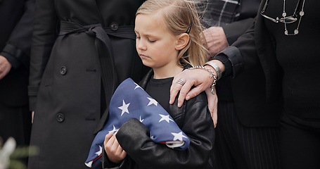 Image showing Funeral, cemetery and girl with American flag for veteran for respect, ceremony and memorial service. Family, depression and sad child by coffin in graveyard mourning military, army and soldier hero