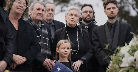 Image showing Funeral, cemetery and family with American flag for veteran for respect, ceremony and memorial service. Sad, depression and people by coffin in graveyard for military hero, army and soldier mourning