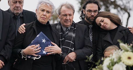 Image showing Funeral, cemetery and family with USA flag for veteran for respect, ceremony and memorial service. Remembrance, depression and sad people by coffin in graveyard mourning military, army and soldier