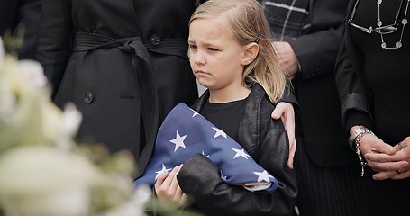 Image showing Funeral, cemetery and child with American flag for veteran for respect, ceremony and memorial service. Family, depression and sad girl by coffin in graveyard mourning military, army and soldier hero