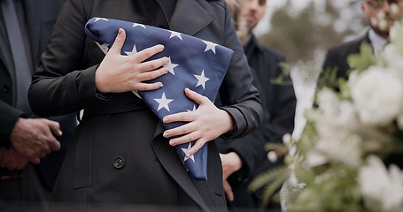 Image showing Hands, american flag and death with a person at a funeral, mourning a loss in grief at a graveyard. War, cemetery and an army wife at a memorial service to say goodbye to a fallen soldier closeup