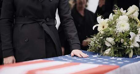 Image showing USA veteran funeral, woman and casket with touch, sad family and flag for mourning, depression and respect. Widow, people and army service with coffin, burial or memorial for war hero in Philadelphia