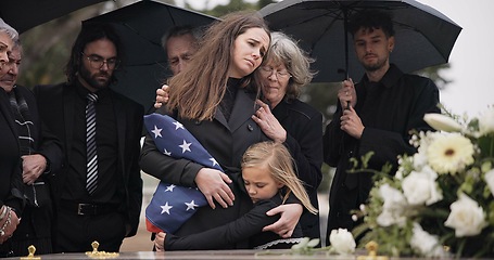 Image showing Funeral, family hug and sad people with grief support, goodbye service and mourning death at burial event. Kid child, mom embrace and group gathering together at coffin, casket and crying at ceremony