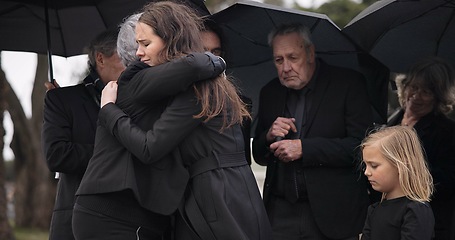 Image showing Funeral, crying family and people hug for grief support, mourning depression and death at emotional burial event. Kid child, mom and group together with widow hugging senior mother at coffin ceremony