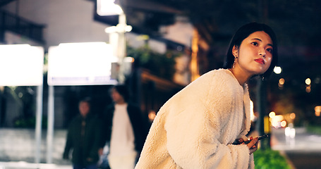 Image showing Japanese woman, taxi and smartphone at night for location, city street and looking for transport. Person, waiting and cab search with cellphone app for travel, road and tokyo town with technology