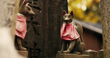 Image showing Fox statue at Shinto shrine in forest with spiritual history, Japanese culture and vintage art in nature. Travel, landmark and stone jinja sculpture in woods with stone animal monument, trees and god