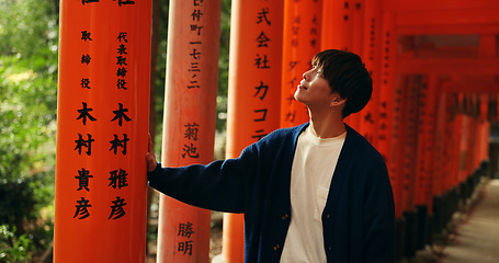 Image showing Thinking, walking and man in Torii gate in Kyoto with peace, mindfulness and travel with spiritual history. Architecture, Japanese culture and person in orange tunnel at Shinto shrine in zen mindset.