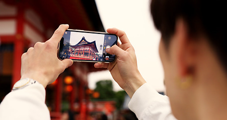 Image showing Phone, hands and tourist with picture in Japan on vacation, holiday trip or travel. Smartphone, person and closeup photography of Fushimi inari-taisha temple in Kyoto on mobile technology outdoor