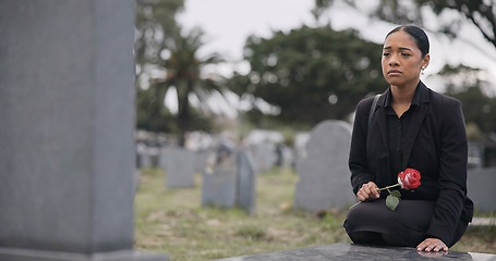 Image showing Sad woman, graveyard and rose on tombstone in mourning, loss or grief at funeral or cemetery. Female person with flower in depression, death or goodbye at memorial or burial service for loved one