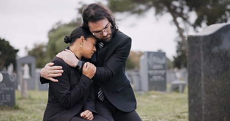 Image showing Sad couple, graveyard and hug in loss, grief or mourning together at funeral, tombstone or cemetery. Man holding woman in comfort, empathy or goodbye at memorial or burial service for death on grass