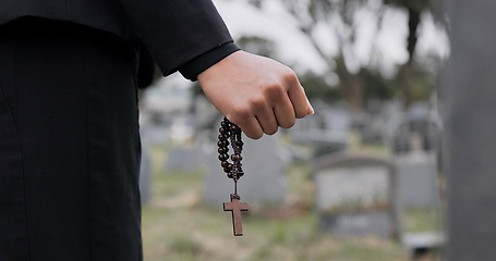 Image showing Rosary, death or hand cemetery for funeral. spiritual service or grave visit to repsect the Christian religion. Mourning, goodbye or closeup of person outside in graveyard for grief, loss or farewell