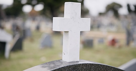 Image showing Funeral, graveyard and cross on tombstone for death ceremony, religion or memorial service. Catholic symbol, background or Christian sign on gravestone for mourning, burial or loss in public cemetery