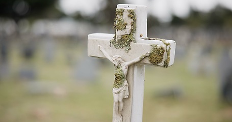 Image showing Funeral, tombstone or jesus on cross in graveyard for death ceremony, religion or memorial service. Symbol, background or Christian sign on gravestone for mourning, burial or loss in public cemetery