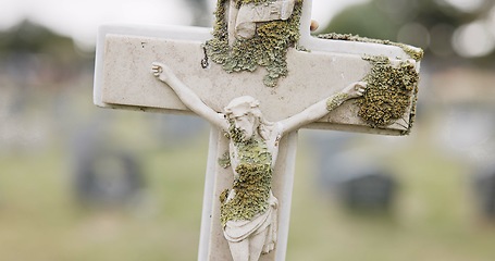 Image showing Funeral, tombstone or Jesus Christ on cross in cemetery for death ceremony, religion or memorial service. Symbol, background or Christian sign on gravestone for burial or loss in public graveyard