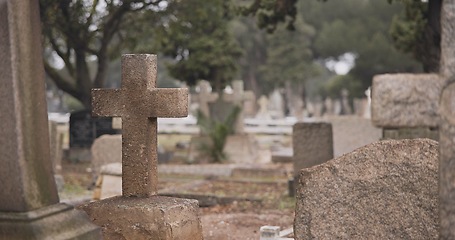 Image showing Funeral, cemetery and cross on tombstone for death ceremony, religion or memorial service. Catholic symbol, background or Christian sign on gravestone for mourning, burial or loss in public graveyard