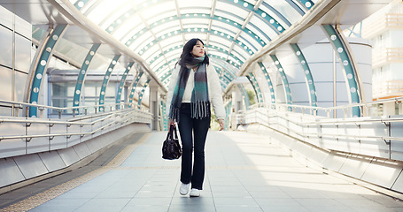 Image showing Bridge, thinking and Japanese woman in city on commute, travel and journey in metro. Walking, fashion and person with trendy clothes, casual style and bag for adventure, holiday and vacation in town