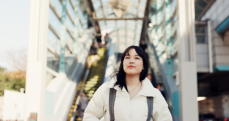 Image showing Walking, thinking and Japanese woman in city on commute, travel and journey in metro. Student, fashion and person with trendy clothes, backpack or bag for university, college and adventure in town