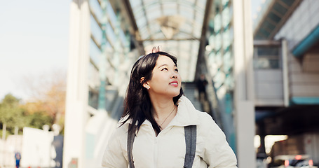 Image showing Walking, thinking and Japanese woman in city on commute, travel and journey in metro. Student, fashion and person with trendy clothes, backpack or bag for university, college and adventure in town