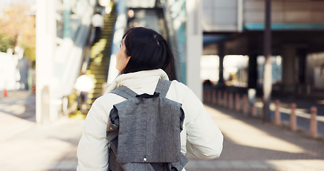Image showing Walking, thinking and Japanese student in city on commute, travel and journey in metro. Student, fashion and woman with trendy clothes, backpack or bag for university, college and adventure in town